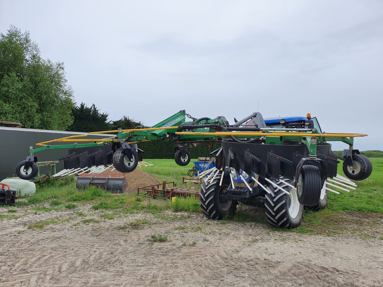 Front mounted rake for grass